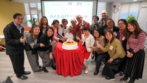 Project team members cuting a cake to celebrate the remarkable achievements of the project so far.